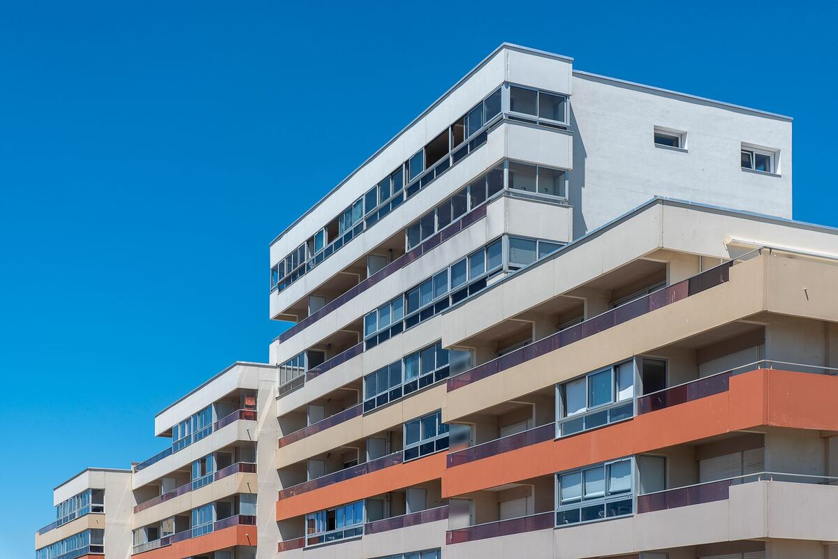 Apartment block with stacked balconies against a clear sky
