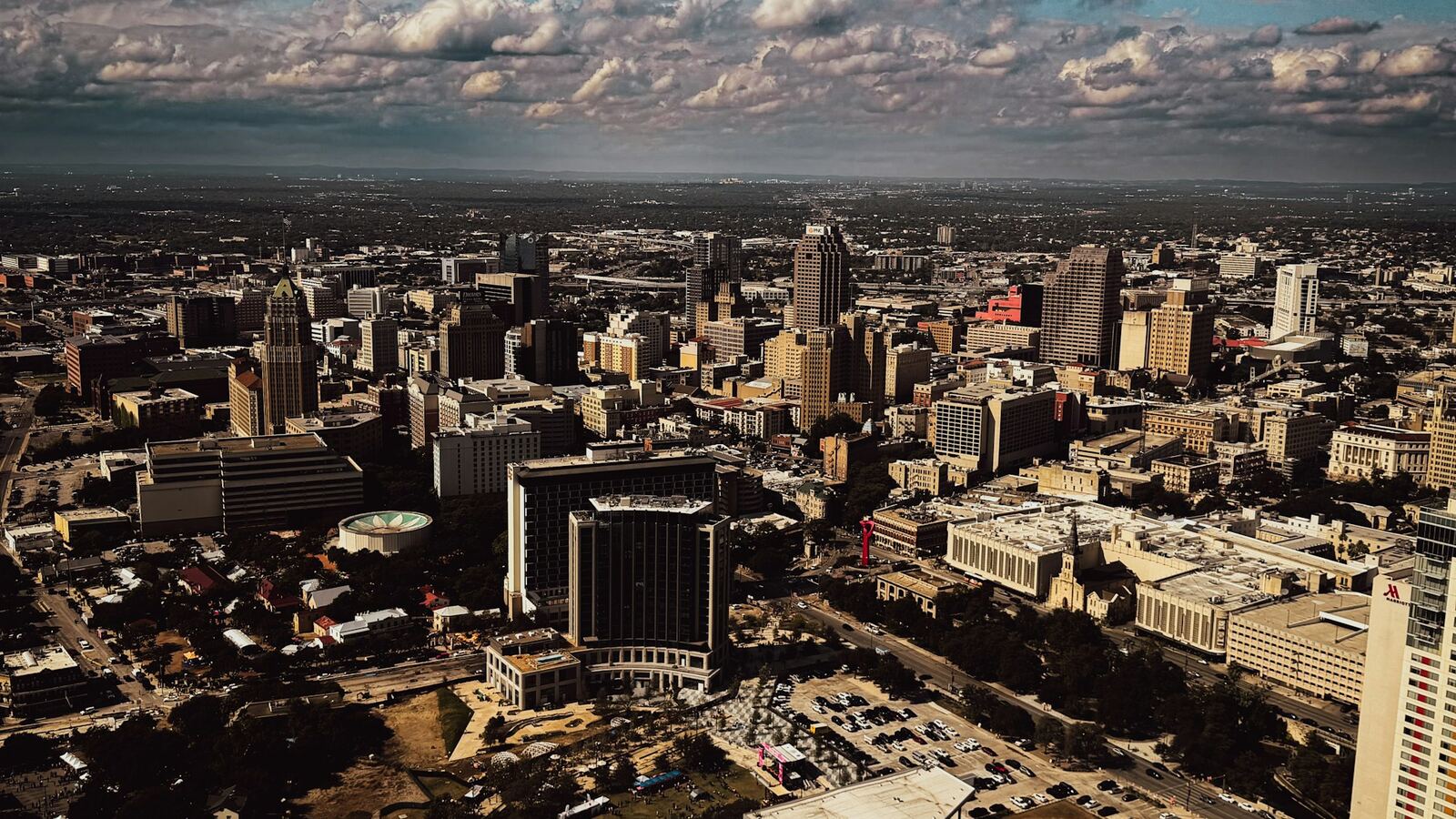 Aerial view over downtown San Antonio under scattered clouds