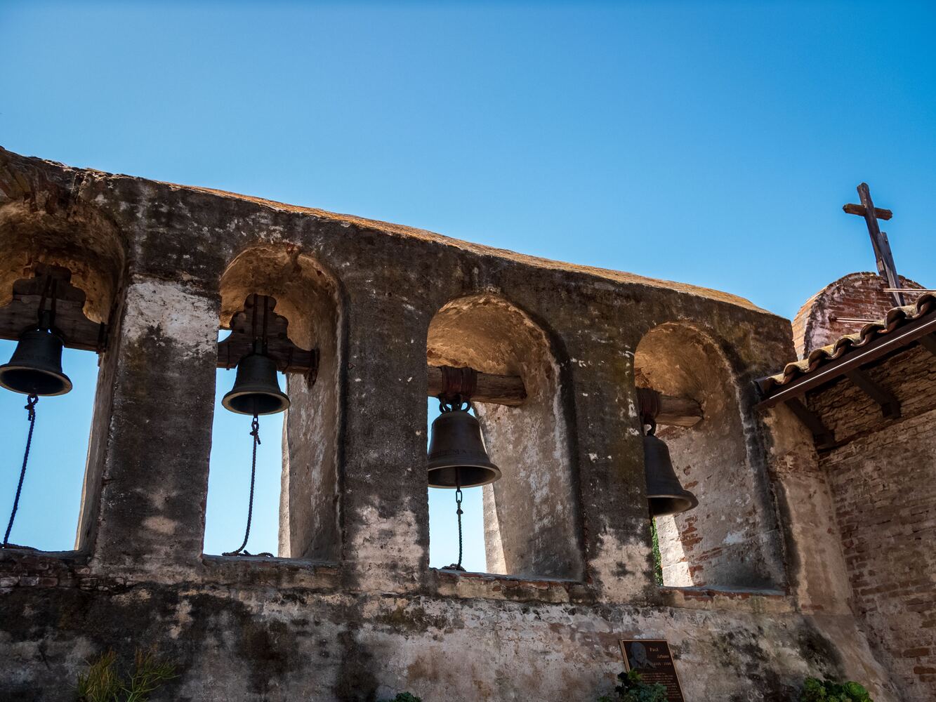 Bells hanging in the stone arches of a San Antonio mission