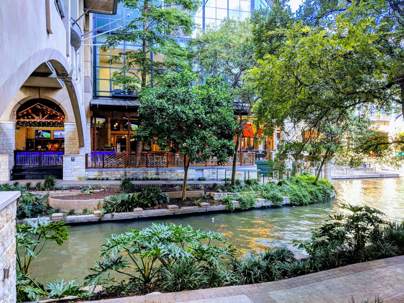 Daytime greenery and terraces along the San Antonio River Walk