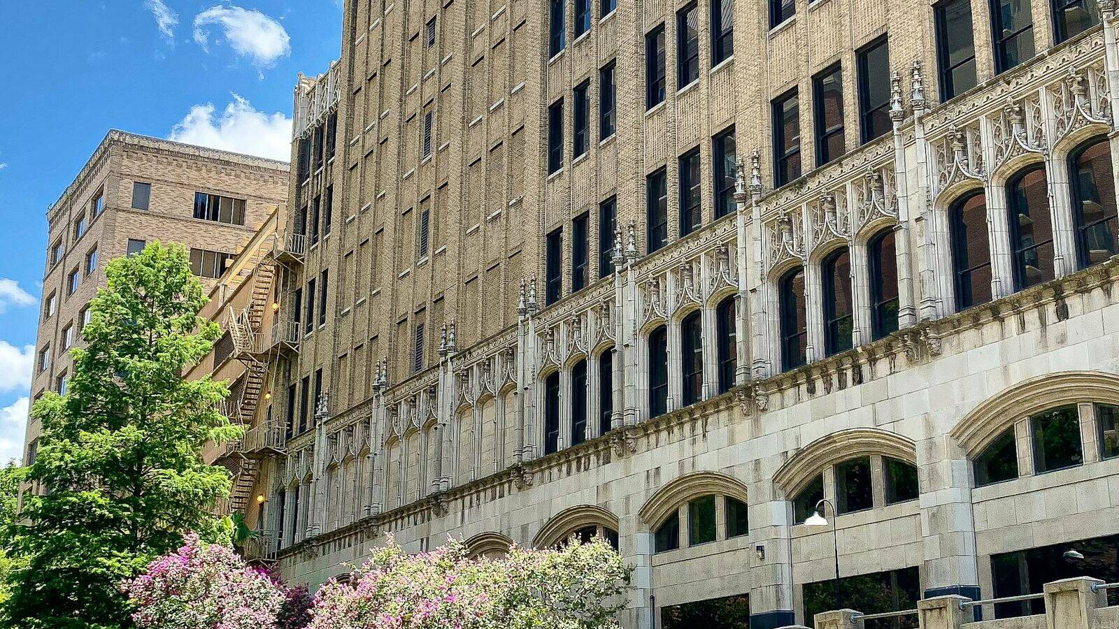 Art Deco building and blooming crepe myrtles above the San Antonio River