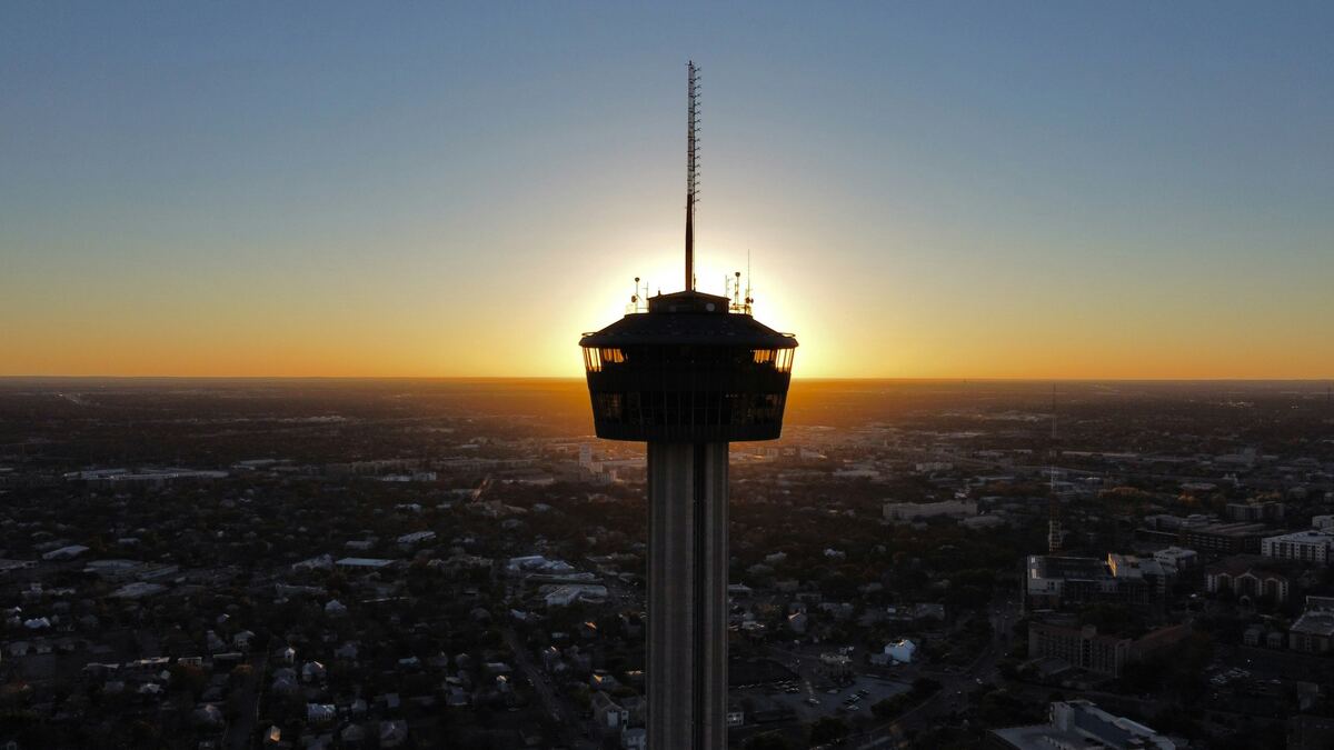 Aerial view of the Tower of the Americas against a San Antonio sunset